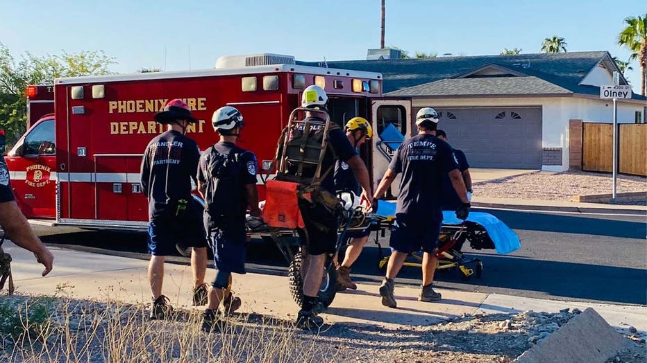 A woman is taken to an ambulance after experiencing heat exhaustion on South Mountain. (Phoenix Fire)