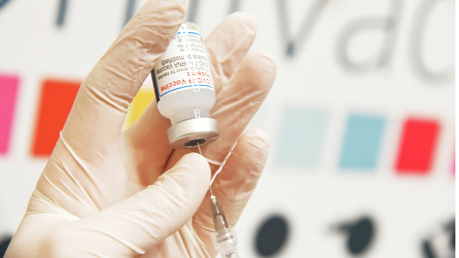A doctor prepares a booster dose of Moderna Covid-19 vaccine