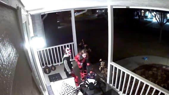 A young trick-or-treater refills house's empty bowl with her own candy: video