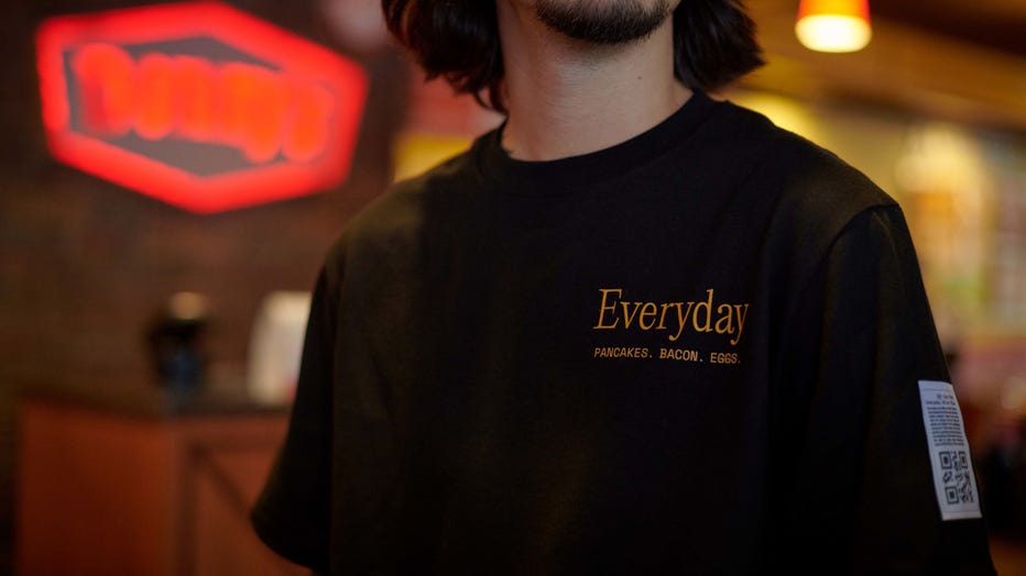The Everyday Value Tee is pictured in a provided image. The shirt comes with a unique QR code to redeem an Everyday Value Slam meal for free every single day for an entire year. (Credit: Denny’s)