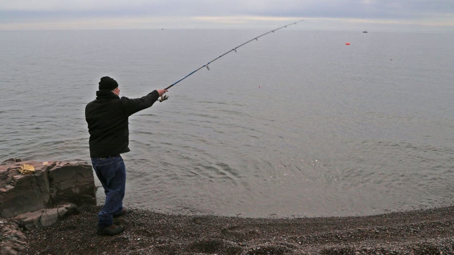 A Lake Superior shore fisherman cast his bait along the North Shore on Monday, fishing for Kamloops rainbow trout.