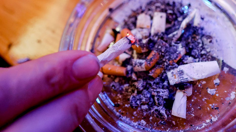 A person ashes his cigarette in a smoking pub. (Photo by Axel Heimken/picture alliance via Getty Images)
