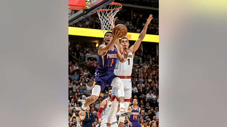 Michael Porter Jr. of the Denver Nuggets forces a miss by Devin Booker of the Phoenix Suns during the second quarter at Ball Arena in Denver on Tuesday, May 9, 2023. (Photo by AAron Ontiveroz/The Denver Post)