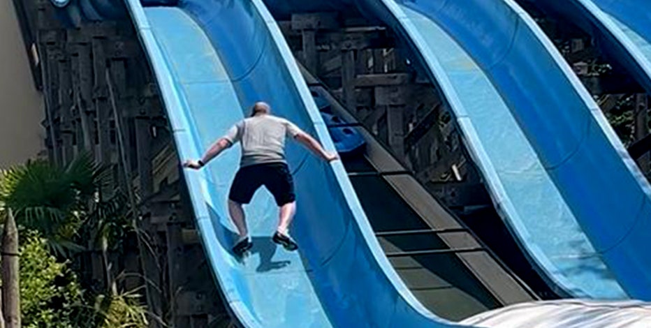 Father scales waterslide to rescue his stuck daughter, video shows