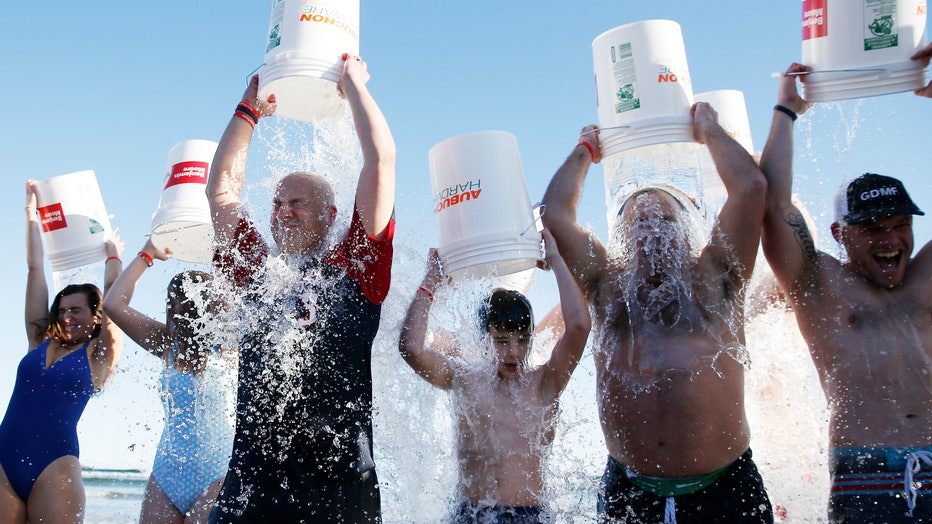 People participate in an ice bucket challenge in 2019. (Photo by Jessica Rinaldi/The Boston Globe via Getty Images)