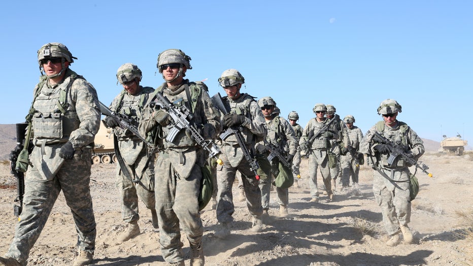 U.S. Army Soldiers from Charlie Battery, 3rd Battalion, 29th Field Artillery Regiment, 3rd Armored Brigade Combat Team, 4th Infantry Division, march in a formation during Decisive Action Rotation 15-02 at the National Training Center on Fort Irwin, Calif., Nov. 11, 2014. (U.S. Army photo by Spc. Randis Monroe/Released)