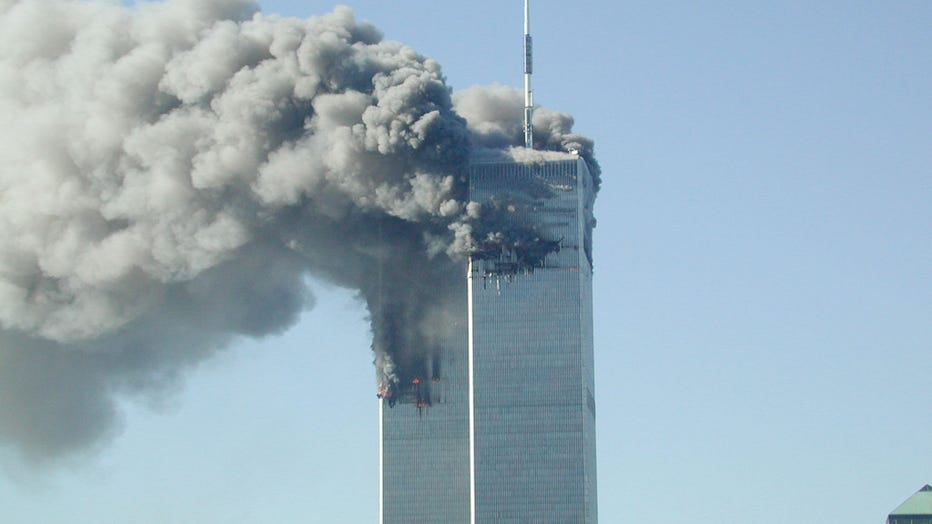 Smoke pours from the World Trade Center after being hit by two planes September 11, 2001. (Photo by Fabina Sbina/ Hugh Zareasky/Getty Images)