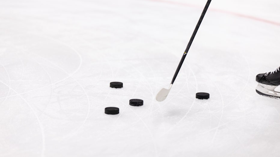 Detail view of pucks and hockey stick before a hockey game (Photo by Brett Carlsen/Getty Images)