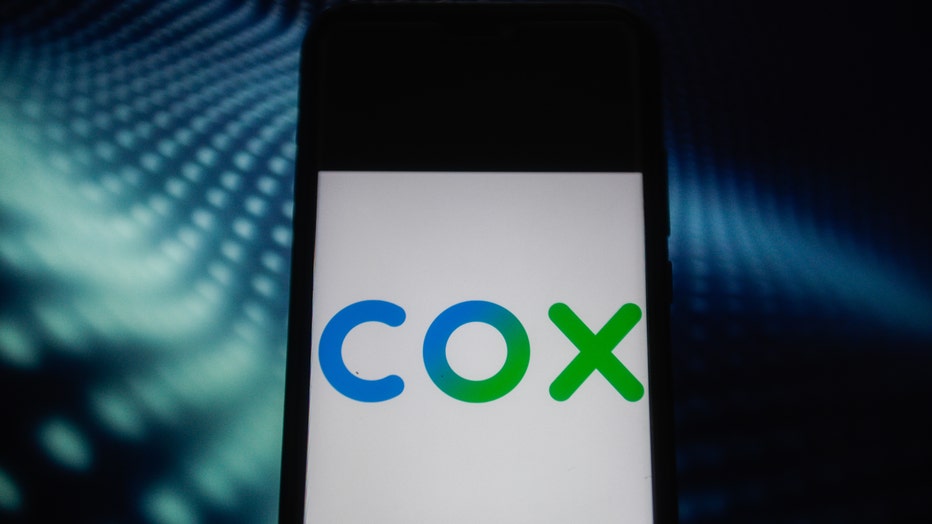 In this photo illustration a Cox Communications logo seen