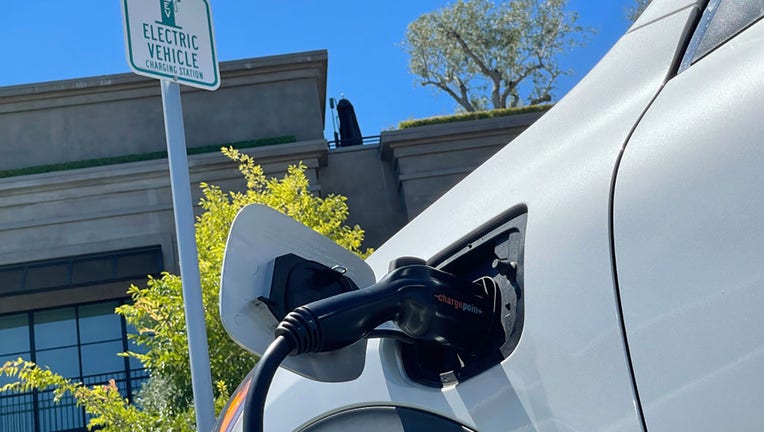 FILE - An electric car charges at a mall parking lot on June 27, 2022, in Corte Madera, California. (Photo by Justin Sullivan/Getty Images)