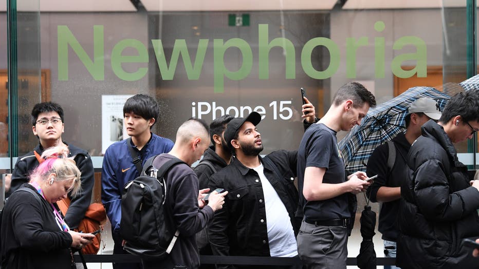 Customers wait in line at the release of the latest iPhone and Apple Watch models at an Apple Store on September 22, 2023. (Photo by James D. Morgan/Getty Images)