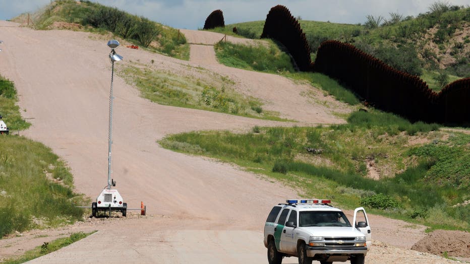 A Border Patrol agent watches the U.S. border with Mexico near Nogales, Ariz. (Photo by Staff Sgt. Jim Greenhill National Guard Bureau)