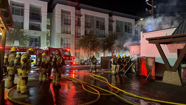 Firefighters extinguish dumpster fire at Phoenix strip mall early on Nov. 9