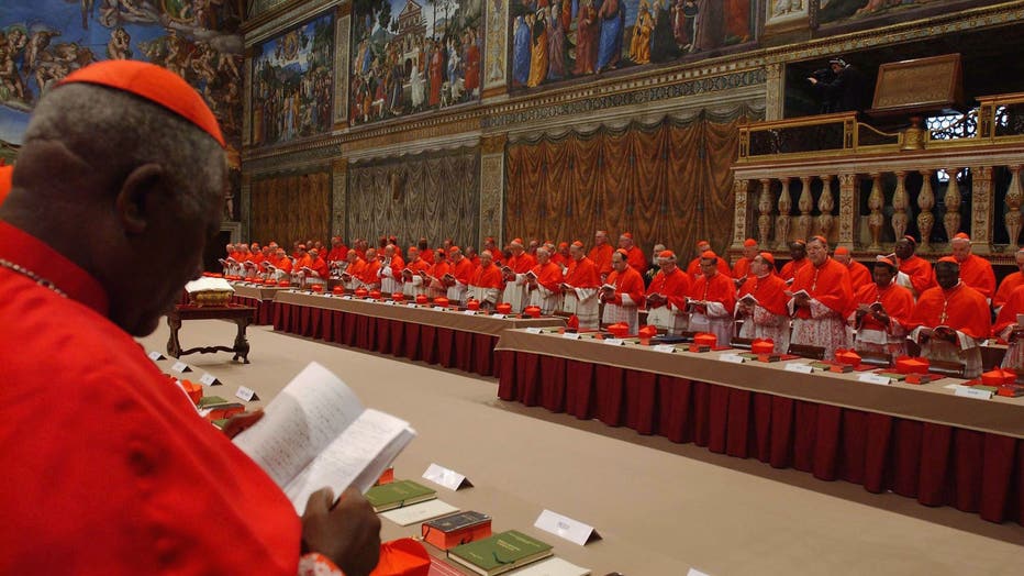 Cardinals of the Catholic Church attend the election conclave in the Sistine Chapel on April 18, 2005 at Vatican City (Photo by Arturo Mari - Vatican Pool/ Getty Images)