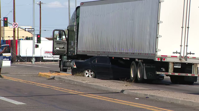 Phoenix driver becomes stuck under semi-truck