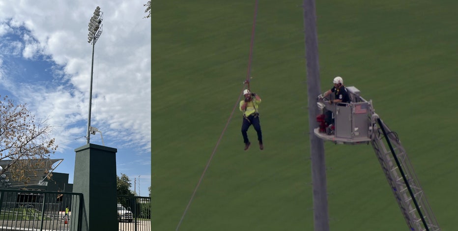 Worker stuck on light pole at Hohokam Stadium