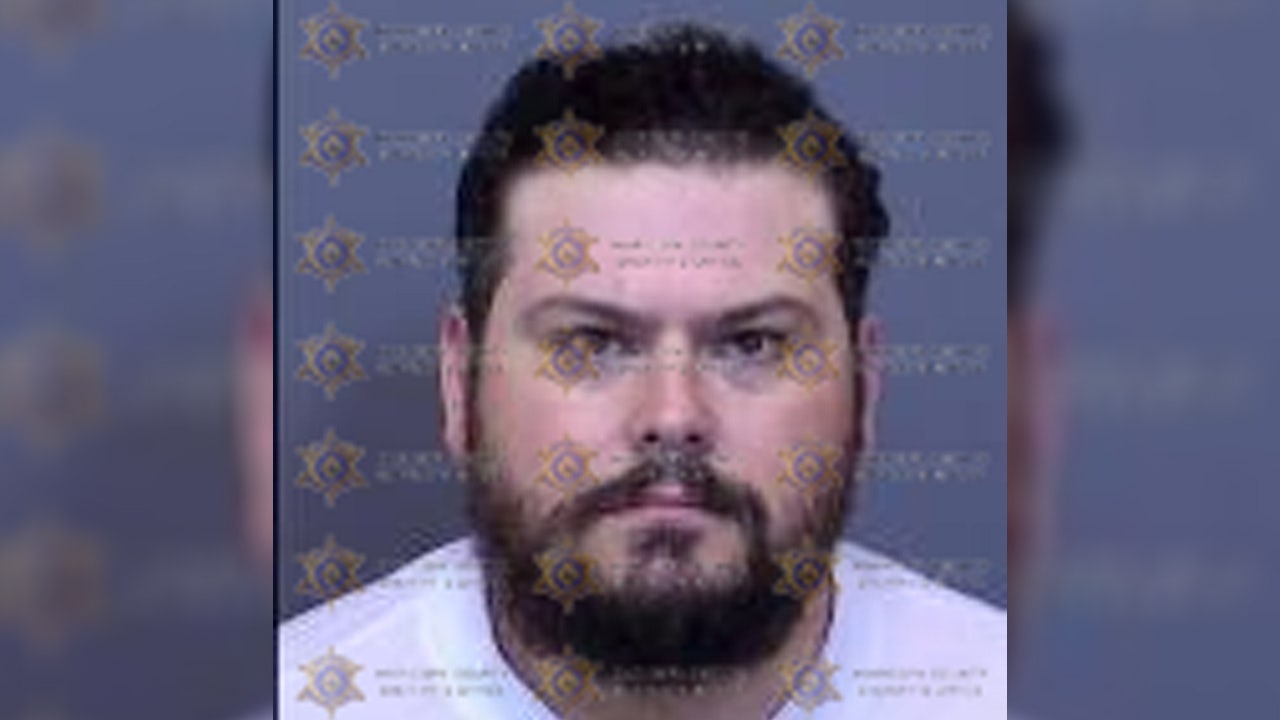 A suspect in a deadly confrontation between rival motorcycle riders in Phoenix has been extradited to Arizona and booked into jail.