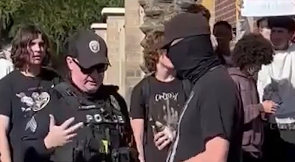 New video shows off-duty, masked Phoenix cop armed at student ICE protest