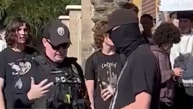 New video shows off-duty, masked Phoenix cop armed at student ICE protest