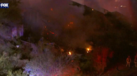 Apache Junction house fire spreads to nearby brush