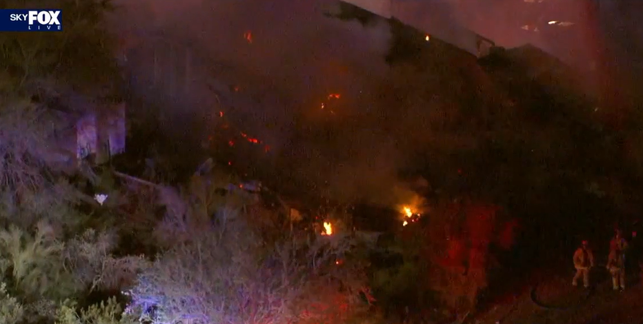 Apache Junction house fire spreads to nearby brush