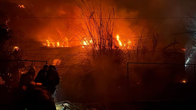 Wind-driven fire burns structures and power poles in Phoenix