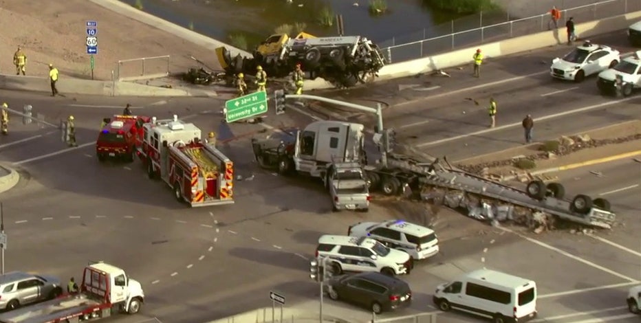 Crash leaves truck partially dangling off I-10 overpass