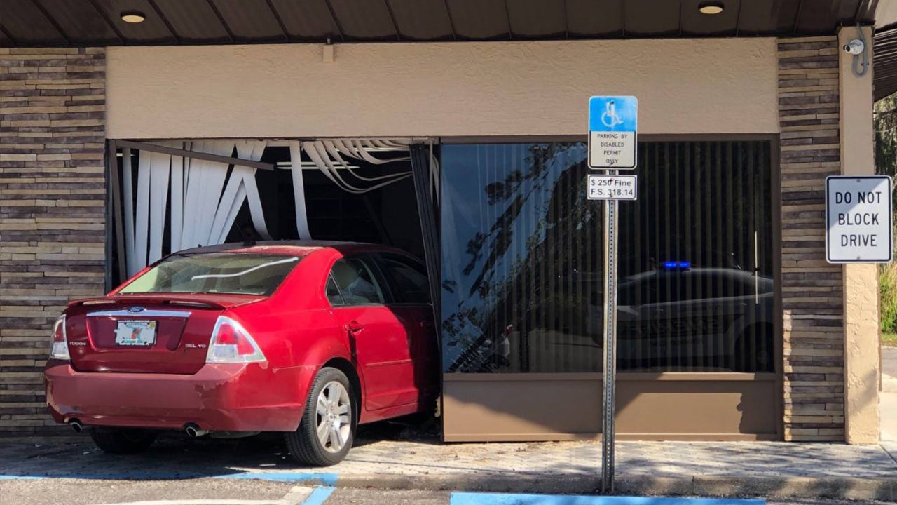 1 injured after car crashes into Brooksville insurance company building