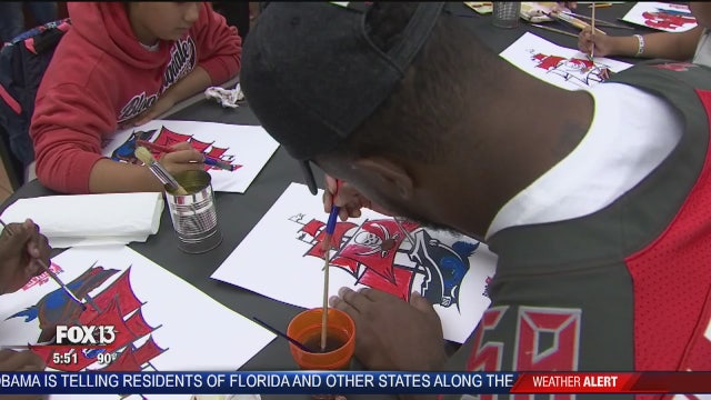 Bucs players, staff get their hands dirty for the kids