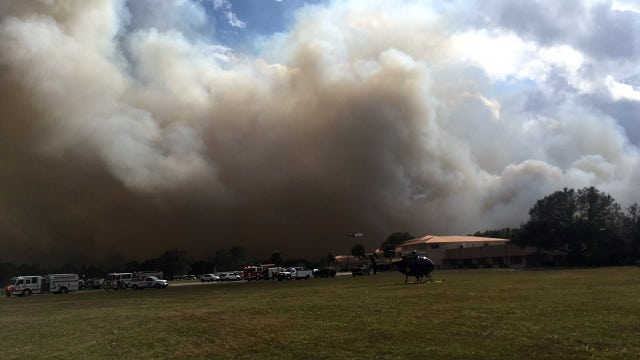 Brush fire threatens homes, prompts evacuations in Polk County
