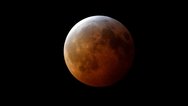 'Super Wolf Blood Moon' eclipse lights up, and darkens, the sky