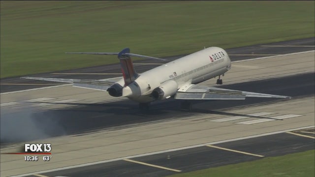 Odd job: Employees blast rubber from TIA runways