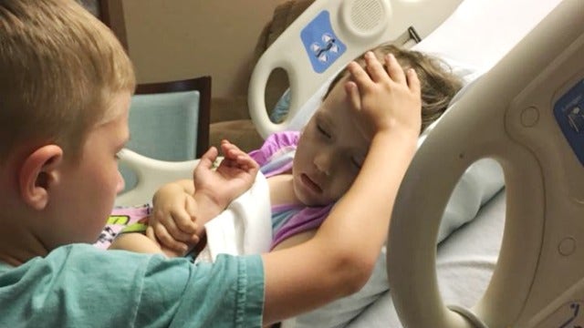 Dad shares heartbreaking photo of son comforting dying sister