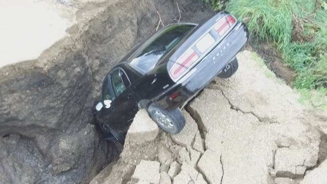 Minnesota teen escapes uninjured after driving into large hole in washed-out road