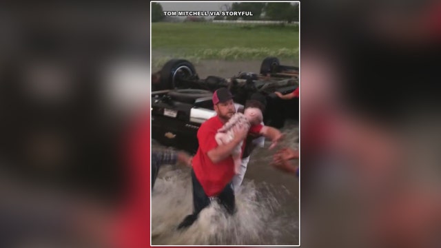 WATCH: Good Samaritans rescue babies from overturned car in rushing water