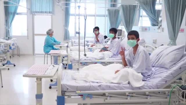 Rescued Thai boys make victory signs from hospital beds