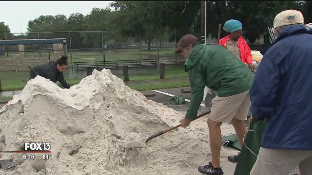 Local officials hand out sandbags to combat area flooding