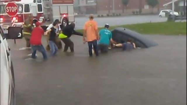 Bystanders form human chain to rescue woman from sinking car