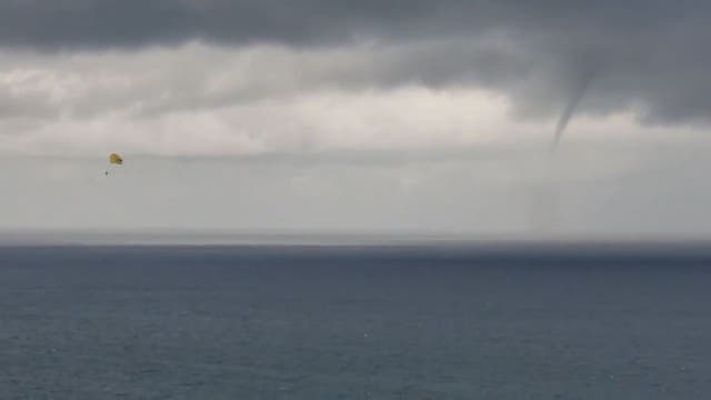 Parasailer spotted on video with waterspout in the background