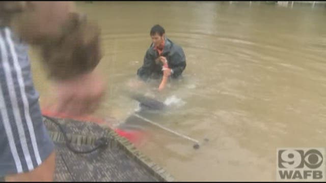 Men surveying Baton Rouge floods save woman, dog from sinking car