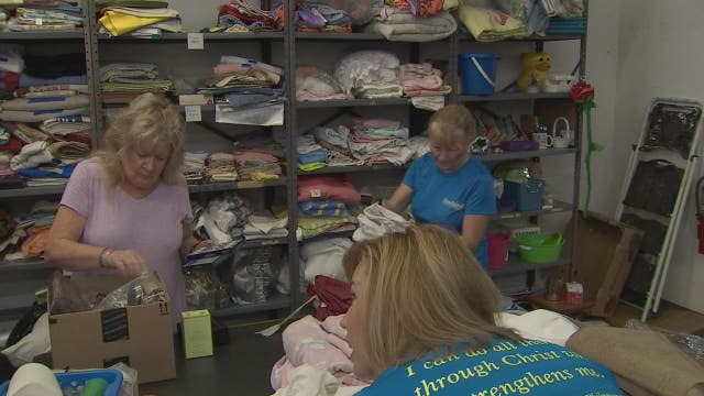 Volunteers help families with basic necessities