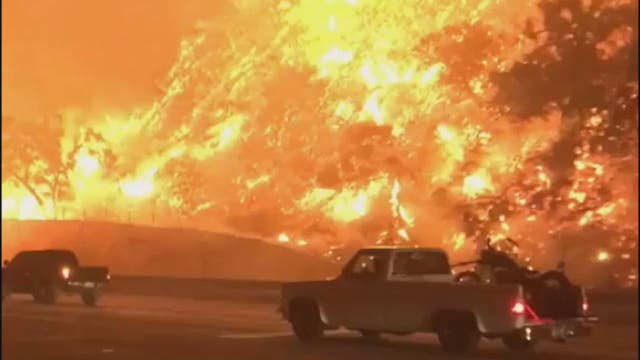 Canyon fire burns dangerously close to traffic along California freeway