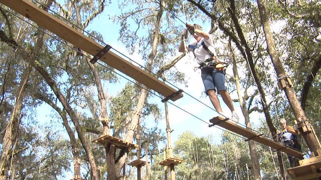Senior women enjoy ziplining adventure together