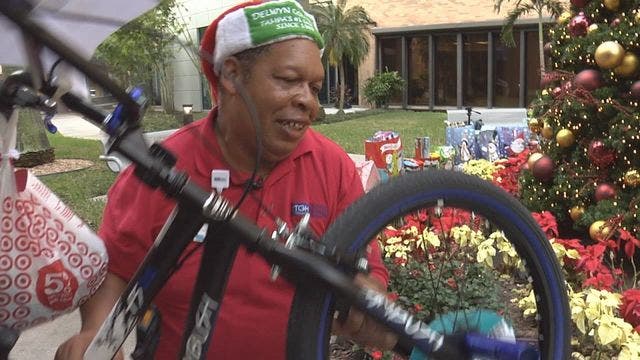TGH employee brings Christmas gifts to children