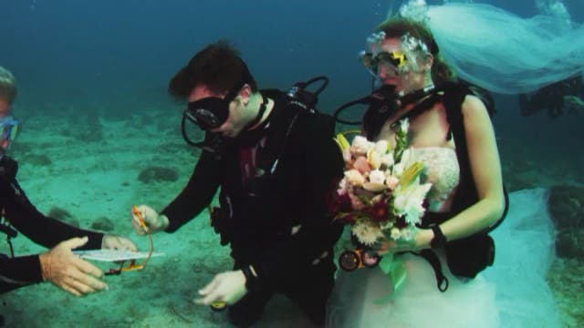Dive trainer marries student in underwater ceremony
