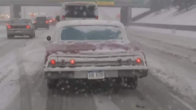 Mechanic drives lowrider car on three wheels after heavy snowfall