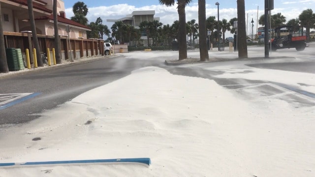 High winds and rain make a mess of roads and runways Friday