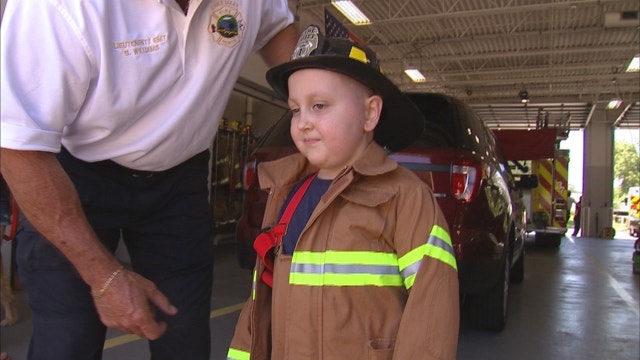 Boy battling brain cancer is fireman for a day