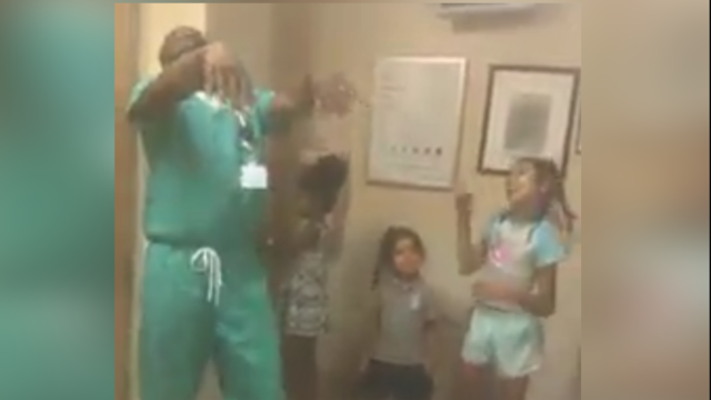 Caught in the Act of Caring: Doctor dances with worried children