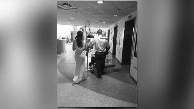 PHOTO: Parents carry son fighting cancer down hallway after hospital wedding